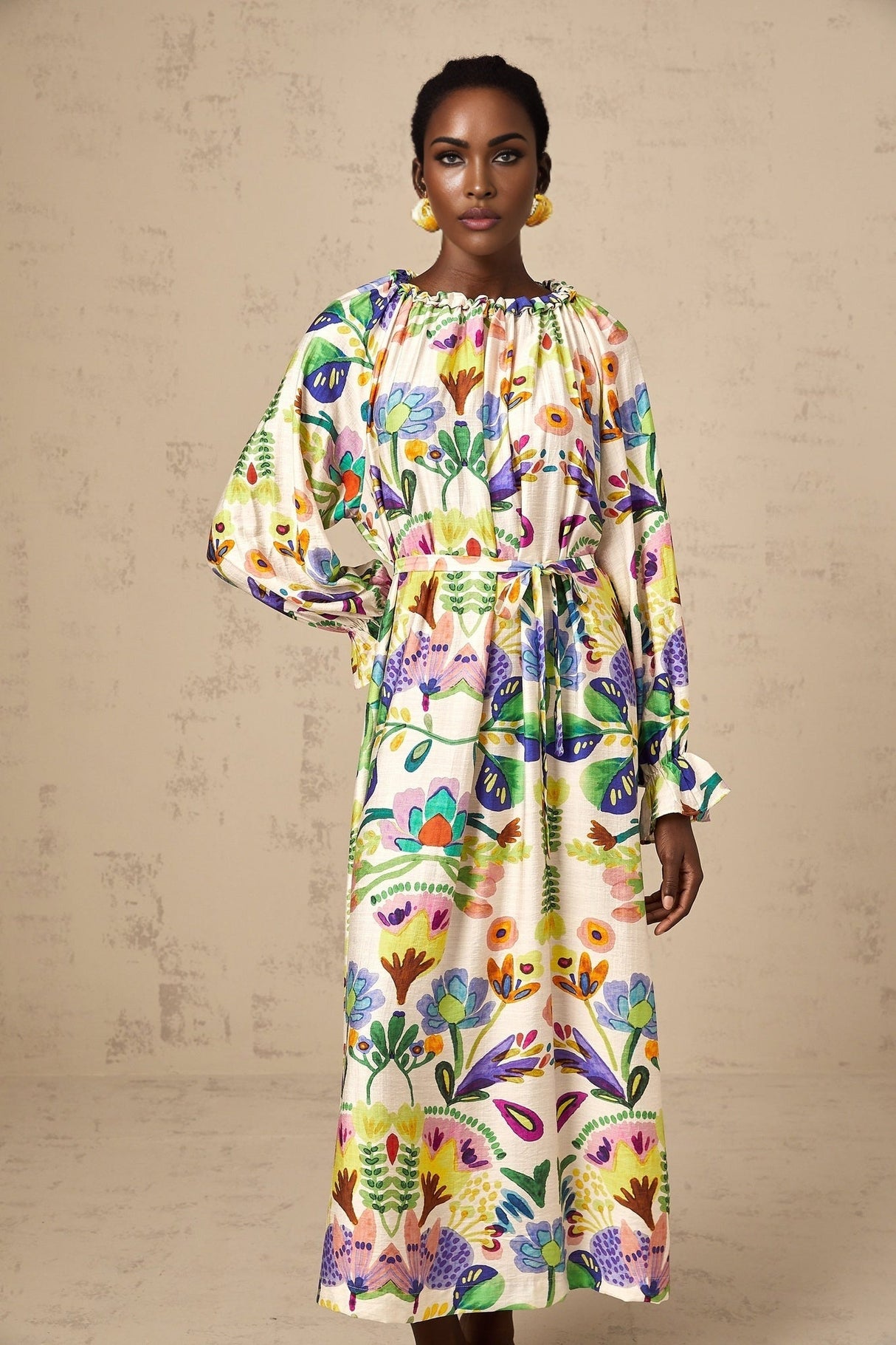 A feminine midi dress with a vibrant paisley print pattern on light poplin fabric featuring a flowing silhouette and delicate details