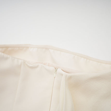 A flared mini dress with a ribbon design named Danae featuring a short skirt and decorative ribbon elements throughout the fabric