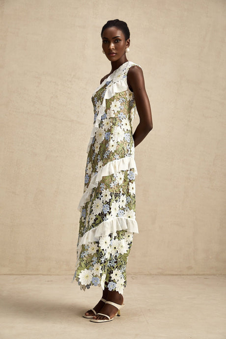 A floral embroidered midi dress with a Clémence design featuring delicate flower patterns on a light fabric