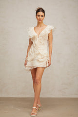 A floral patterned mini dress with layered ruffles and a faux flower design in soft pastel colors