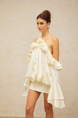 A floral patterned mini dress with ruffled coldshoulder design and a vibrant fleur print