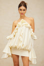 A floral patterned mini dress with ruffled details and offtheshoulder sleeves featuring a predominantly floral design