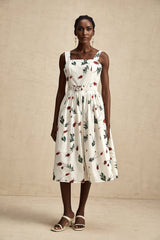 A floral print midi dress with a poplin fabric featuring a white background and colorful flower pattern throughout