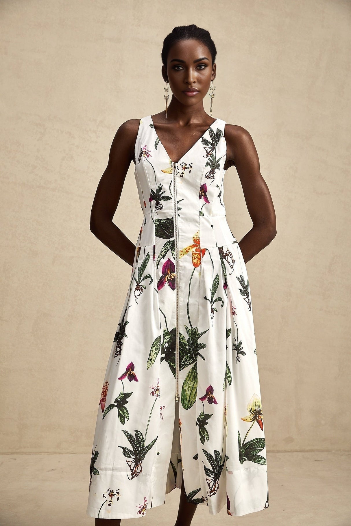 A floral print midi dress with a vneck and poplin fabric featuring a colorful Magali design on a light background