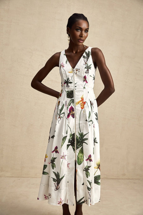 A floral print midi dress with a vneck neckline made from poplin fabric The dress features a vibrant floral pattern on a light background and has a fitted bodice with a flowy skirt that falls to mid calf length