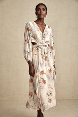 A floral print midi dress with an open waist design featuring a colorful pattern on a light background The dress has a flowing silhouette and appears to be made of lightweight fabric suitable for warmer weather