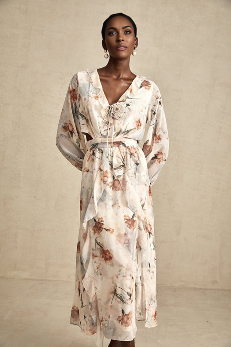 A floral print midi dress with an open waist design featuring a colorful pattern on a light background The dress has a flowing silhouette and hits below the knee