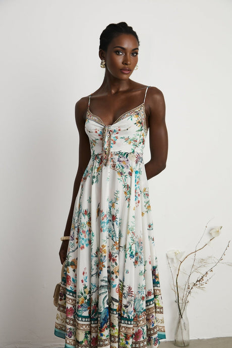 A floral print midi dress with decorative elements inspired by Philippine design featuring a colorful pattern and embellishments on a flowing silhouette