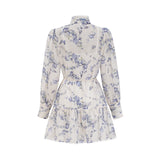 A floral print mini dress with a flared skirt made from chiffon fabric The dress features a mix of colorful flowers on a light background and has a short length with a flowing silhouette