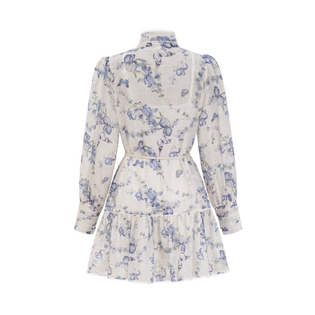 A floral print mini dress with a flared skirt made from chiffon fabric The dress features a mix of colorful flowers on a light background and has a short length with a flowing silhouette