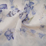 A floral print mini dress with a flared skirt made of chiffon fabric featuring a delicate floral pattern on a light background with short sleeves and a fitted bodice