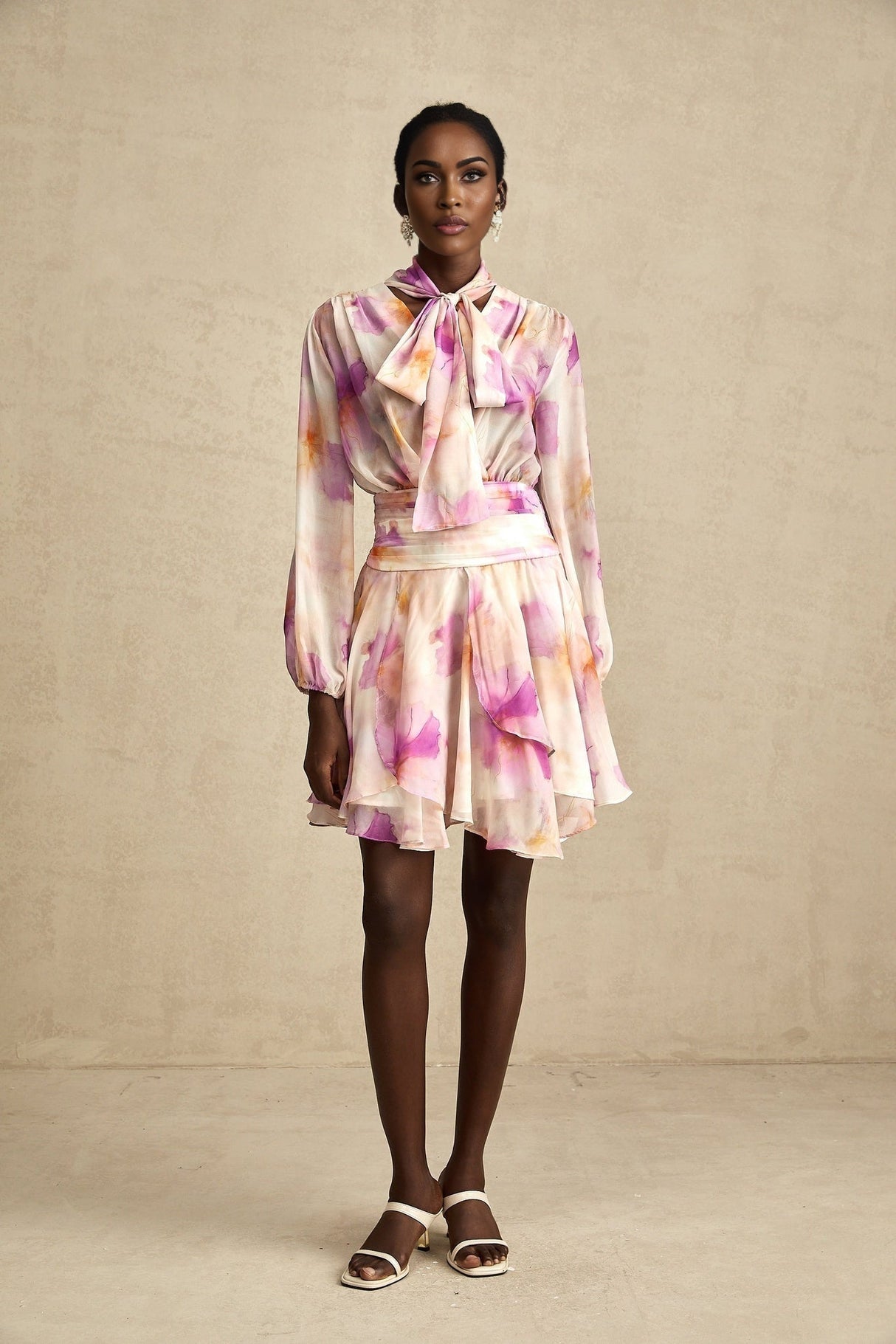 A floral print mini dress with a Vneck design from Maelys featuring a vibrant pattern and short length