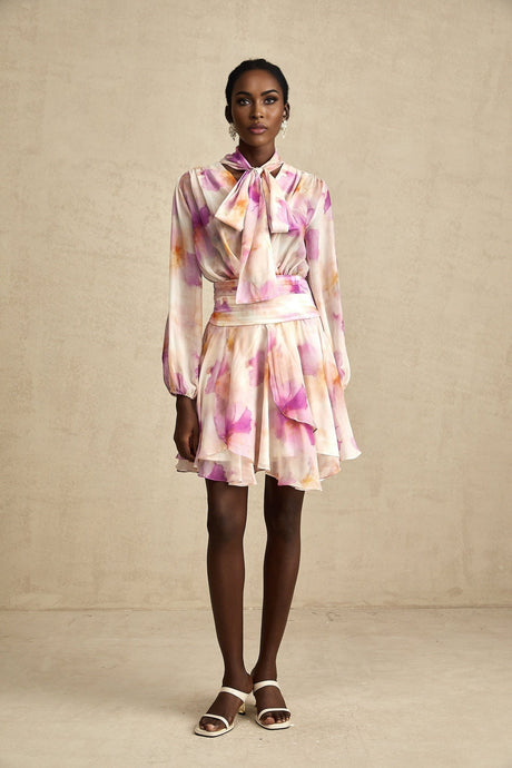 A floral print mini dress with a Vneck design from Maelys featuring a vibrant pattern and short length