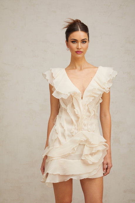 A floral print mini dress with layered ruffles and a faux flower design featuring a short hemline and feminine silhouette