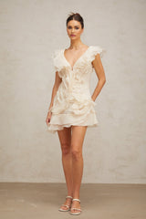 A floral print mini dress with layered ruffles and a faux flower design