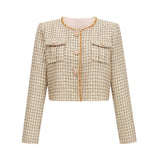 A gold tweed jacket and matching skirt set adorned with sequins creating a shimmering elegant ensemble