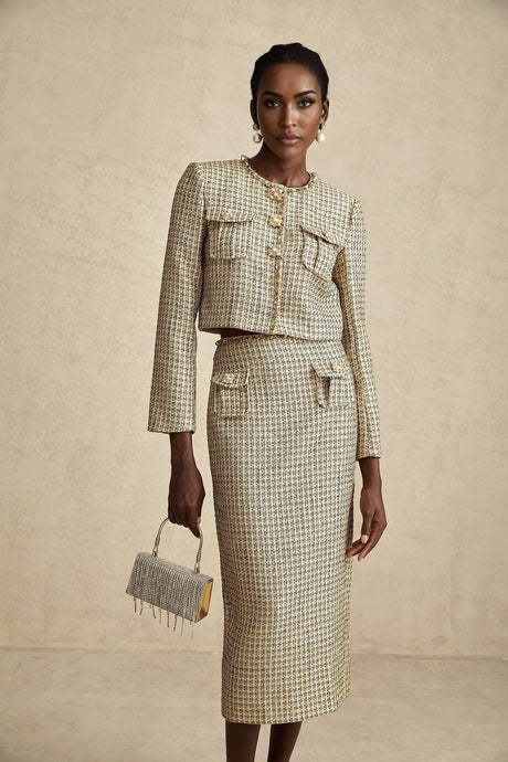 A gold tweed jacket and matching skirt set embellished with sequins creating a shimmering elegant ensemble