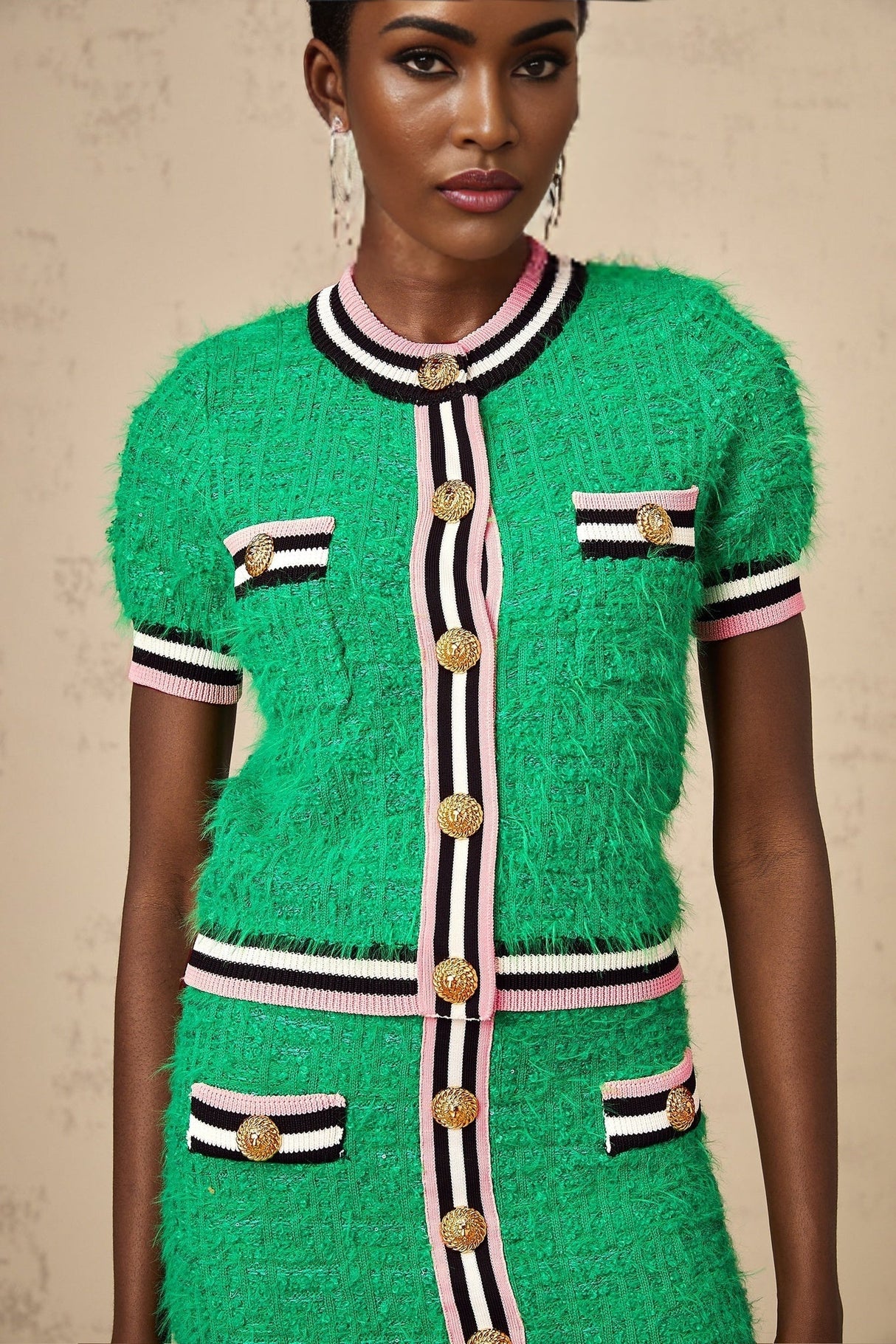 A green knitted two piece outfit consisting of a top and skirt in a matching set called Camille
