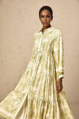 A green midi dress with a graphic print pattern named Adelaide worn by a model standing in a relaxed pose