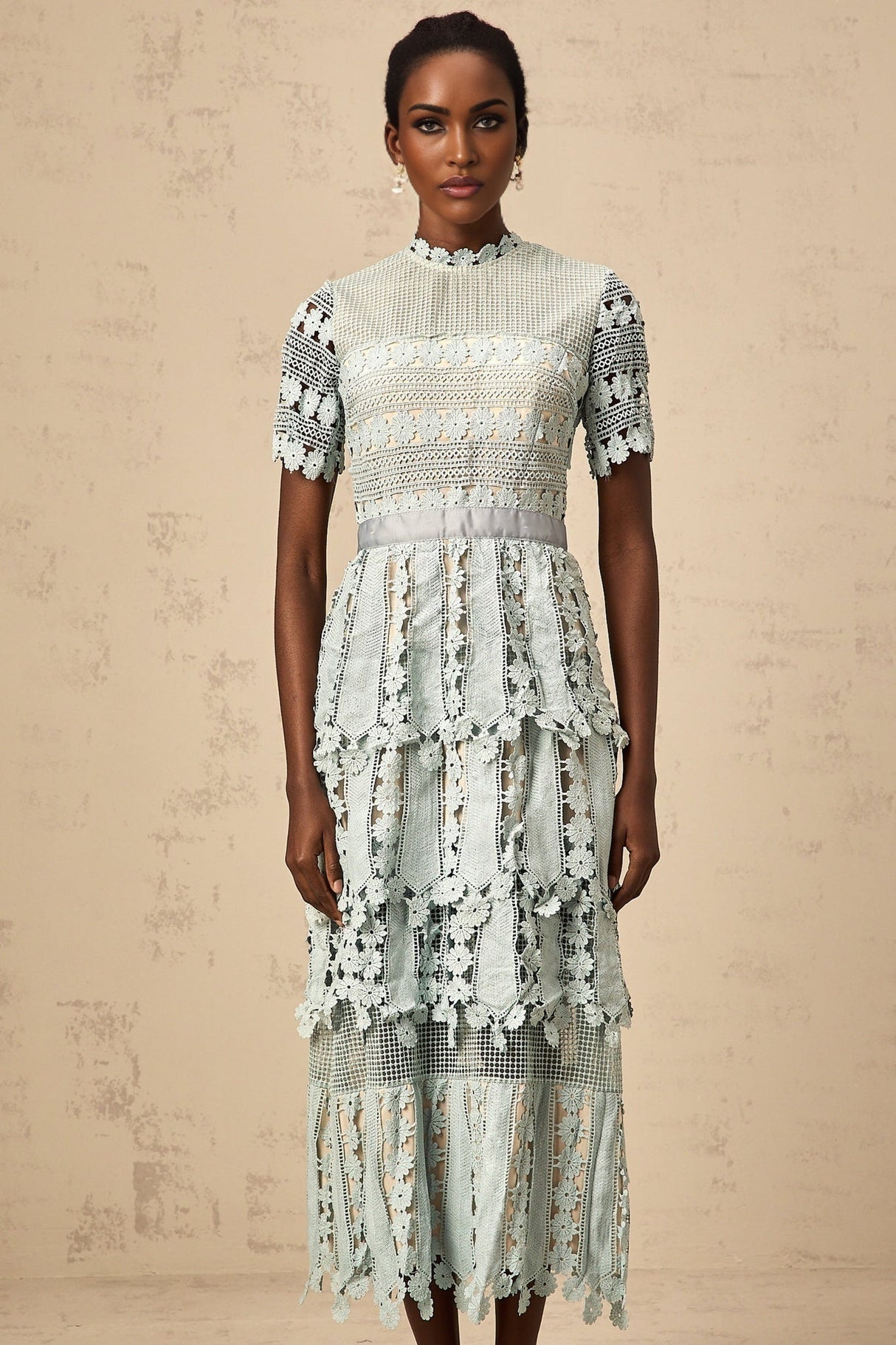 A green midi dress with floral embroidery patterns featuring a design inspired by the ocean