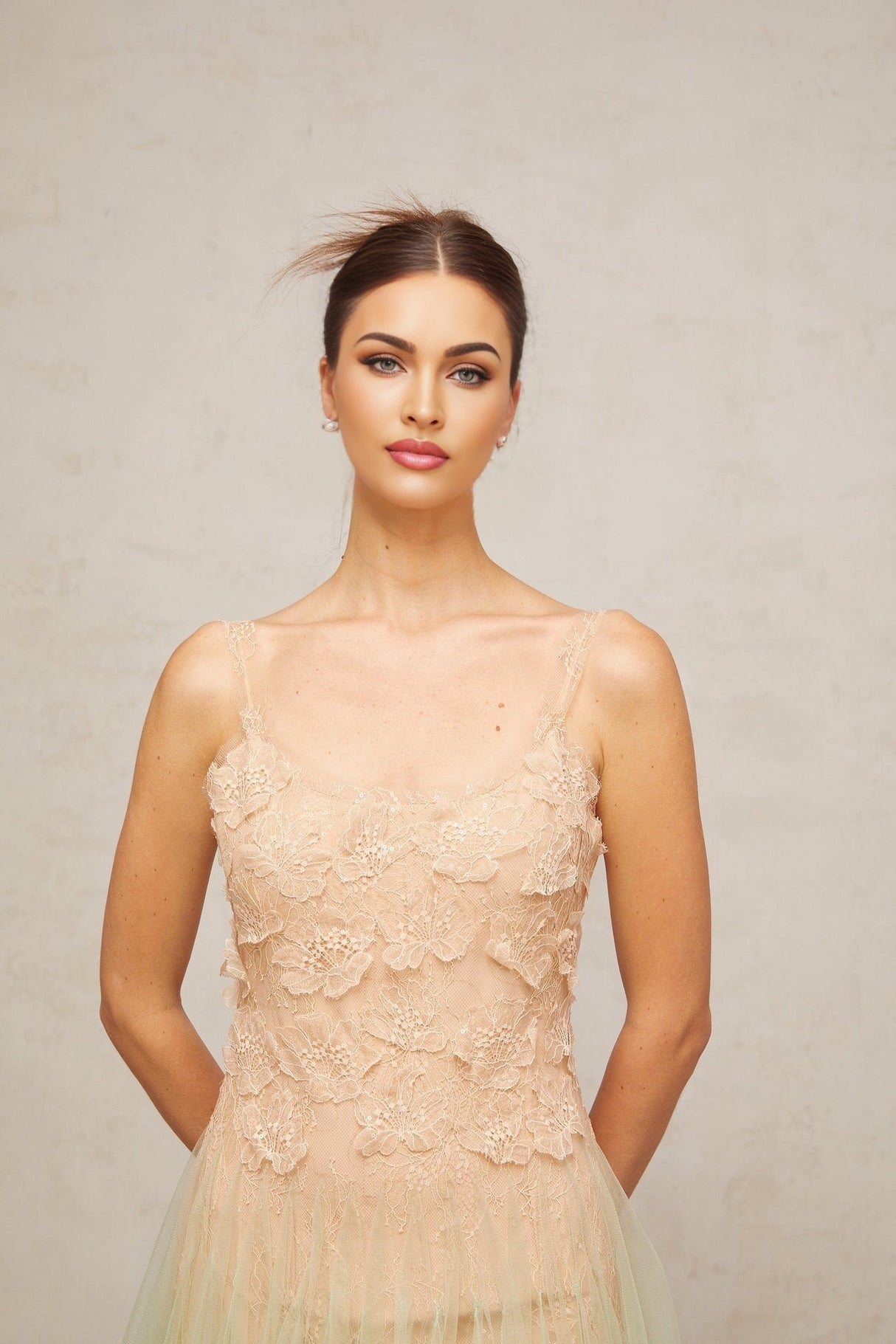 A green midi dress with lace panelling and tulle fabric featuring a delicate feminine design