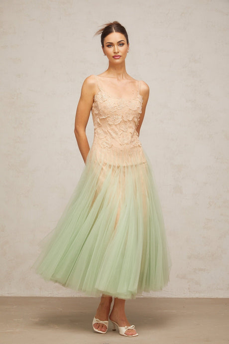 A green midi dress with lace panelling and tulle fabric featuring a slim silhouette and delicate details