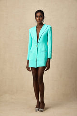 A green mini dress with a blazerstyle top and cinched waist detail
