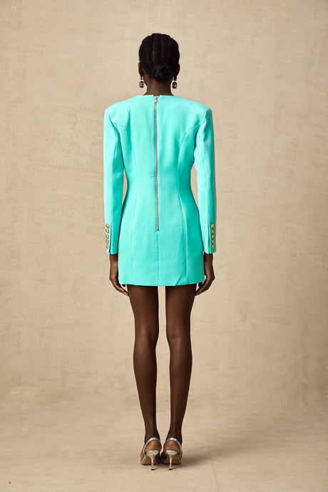 A green mini dress with a blazerstyle top and cinched waist detail