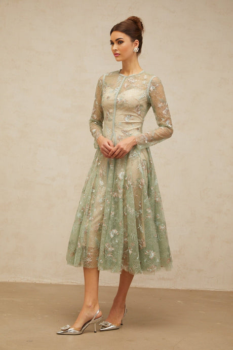 A green pleated midi dress with floral embroidery details featuring a design called Philomene