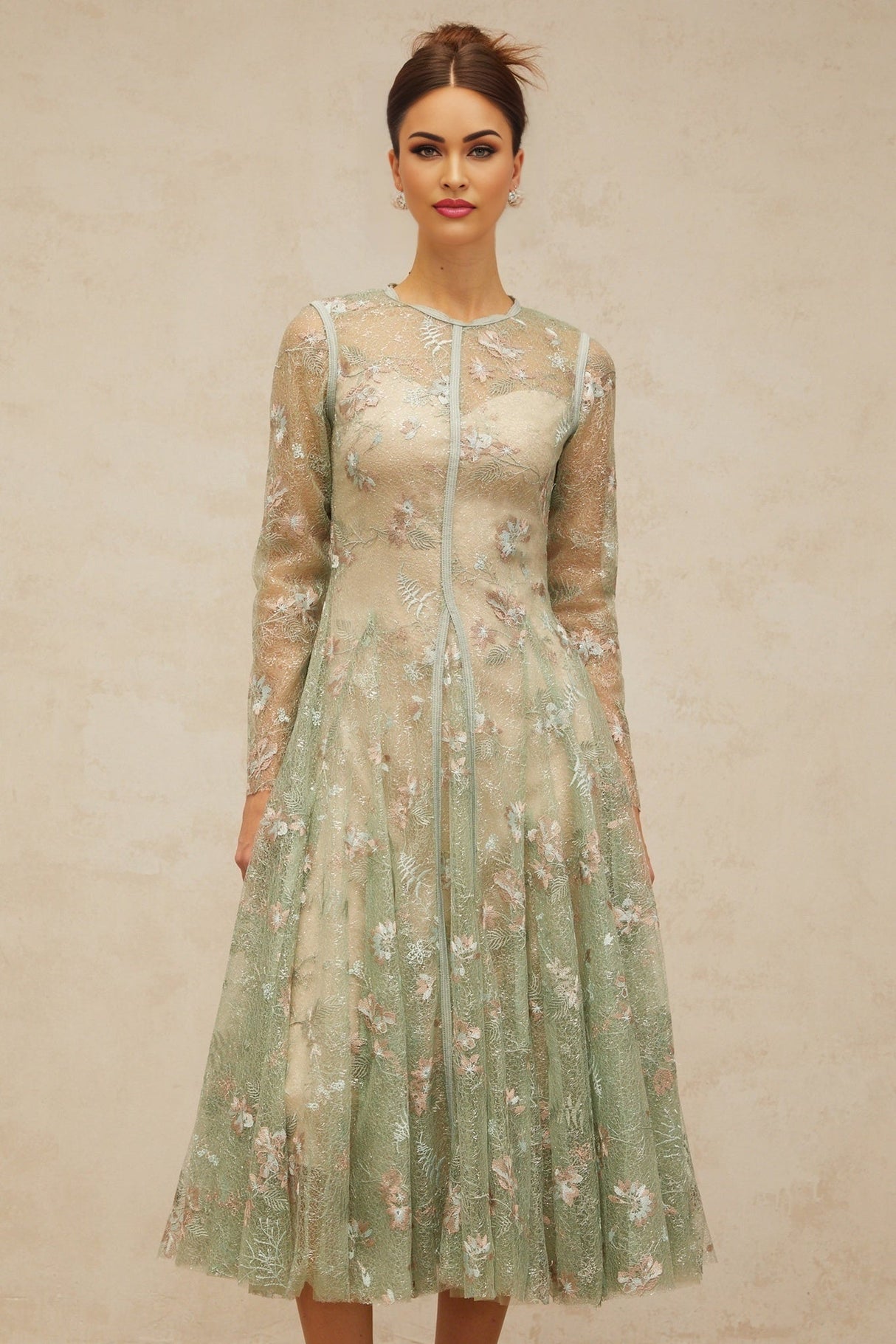 A green pleated midi dress with floral embroidery details featuring a design called Philomene