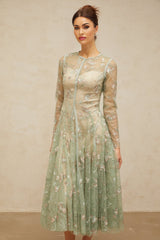 A green pleated midi dress with floral embroidery details named Philomene shown on a mannequin or model against a plain background