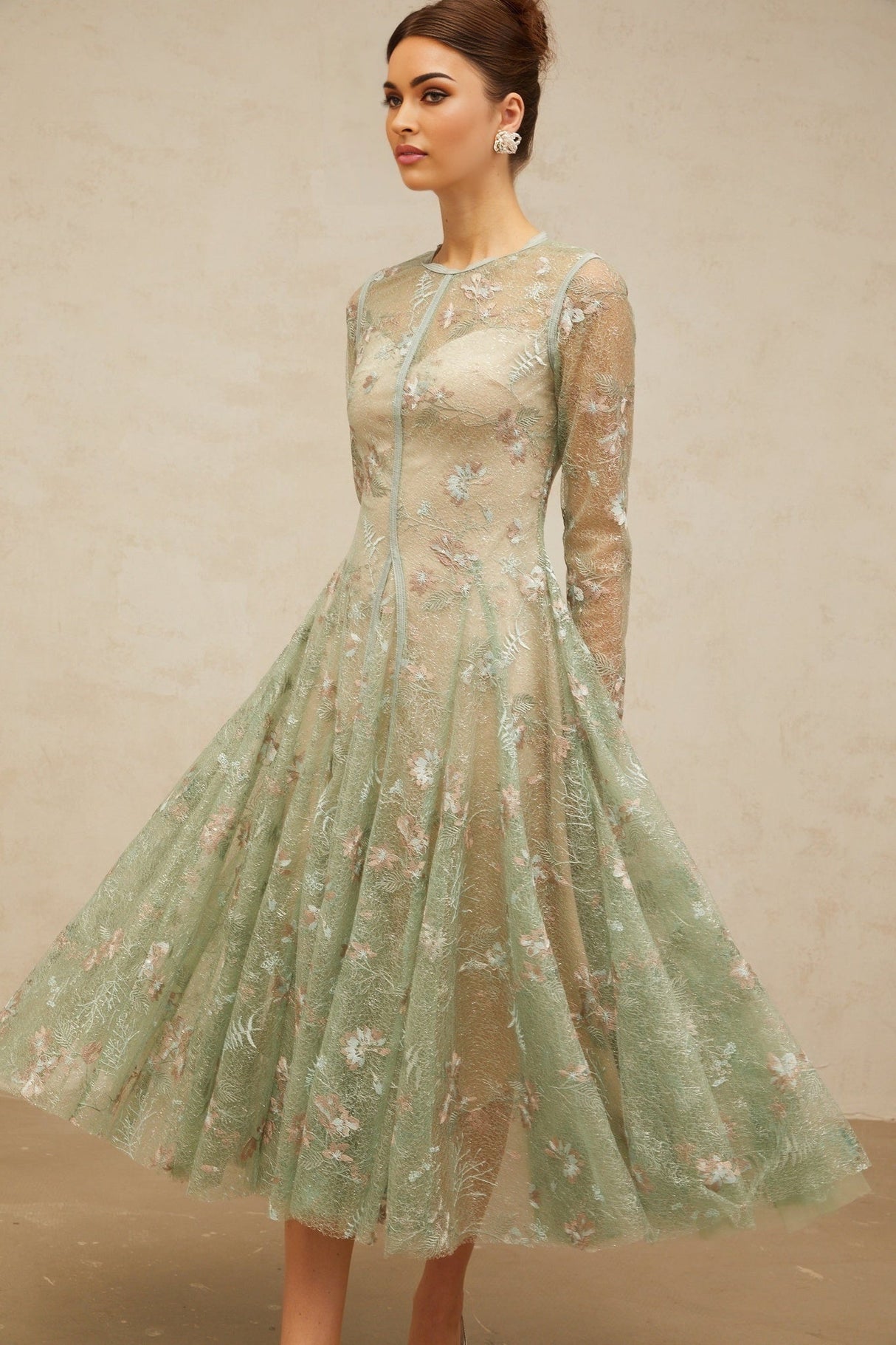 A green pleated midi dress with floral embroidery details named Philomene