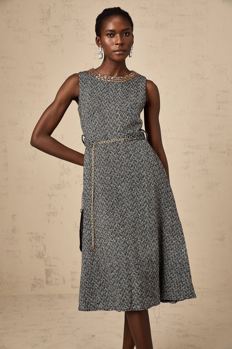 A grey sleeveless tweed midi dress with crystal embellishments suitable for Valentines Day occasion featuring a fitted silhouette and textured fabric
