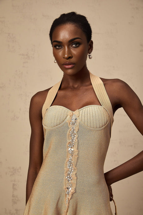 A khaki colored mini dress with knitted fabric and embellishments named Gabrielle featuring a short length and decorative details