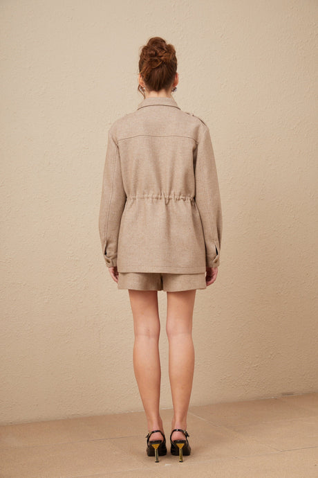 A khaki colored wool twill jacket and matching culottes set from Clarisse shown together as a coordinated outfit
