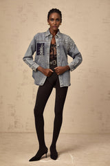 A light blue denim shirt adorned with small rhinestones scattered across the fabric creating a sparkling effect