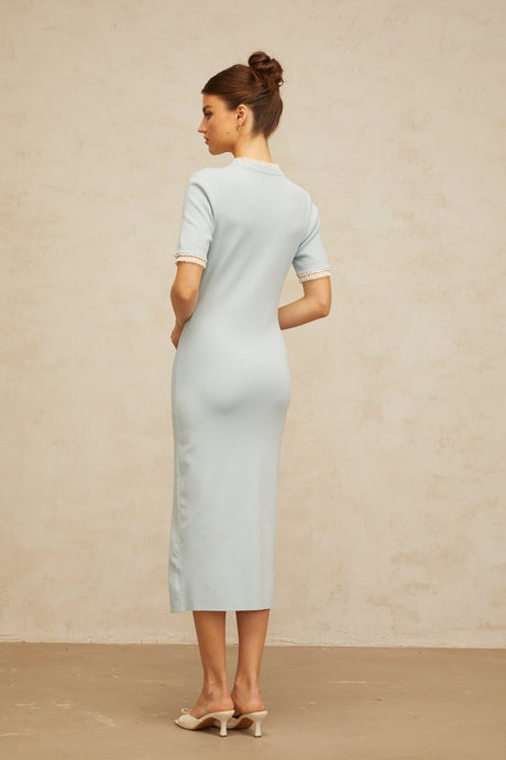 A light blue knit midi dress with a pencil silhouette featuring a fitted shape that hugs the body
