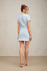 A light blue knit mini dress with crystal embellishments featuring a fitted silhouette and short hemline