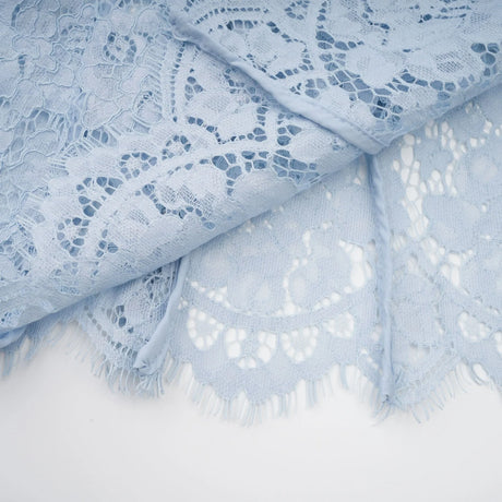 A light blue midi dress with floral lace pattern featuring boned structure and Audrey style neckline