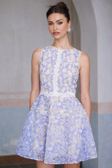A light blue mini dress with crochet lace detailing and puff sleeves on a white background