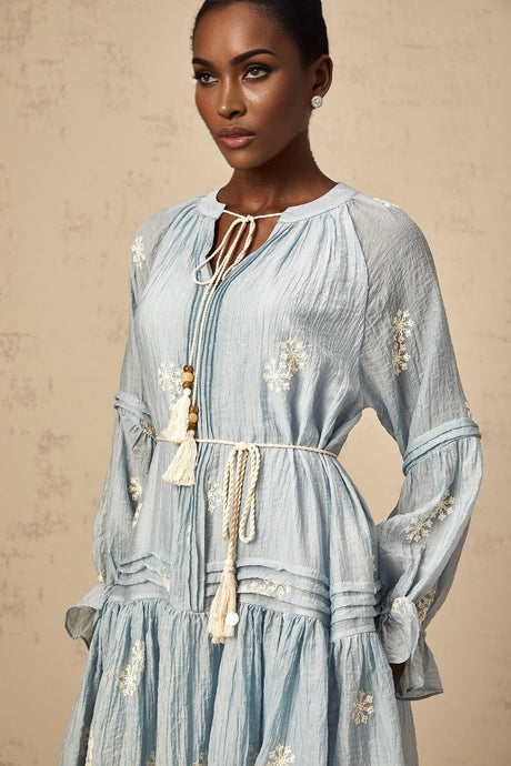A light blue mini dress with delicate floral embroidery decorating the fabric featuring a feminine silhouette and short hemline