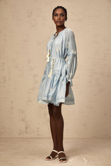 A light blue mini dress with delicate floral embroidery details and a feminine silhouette