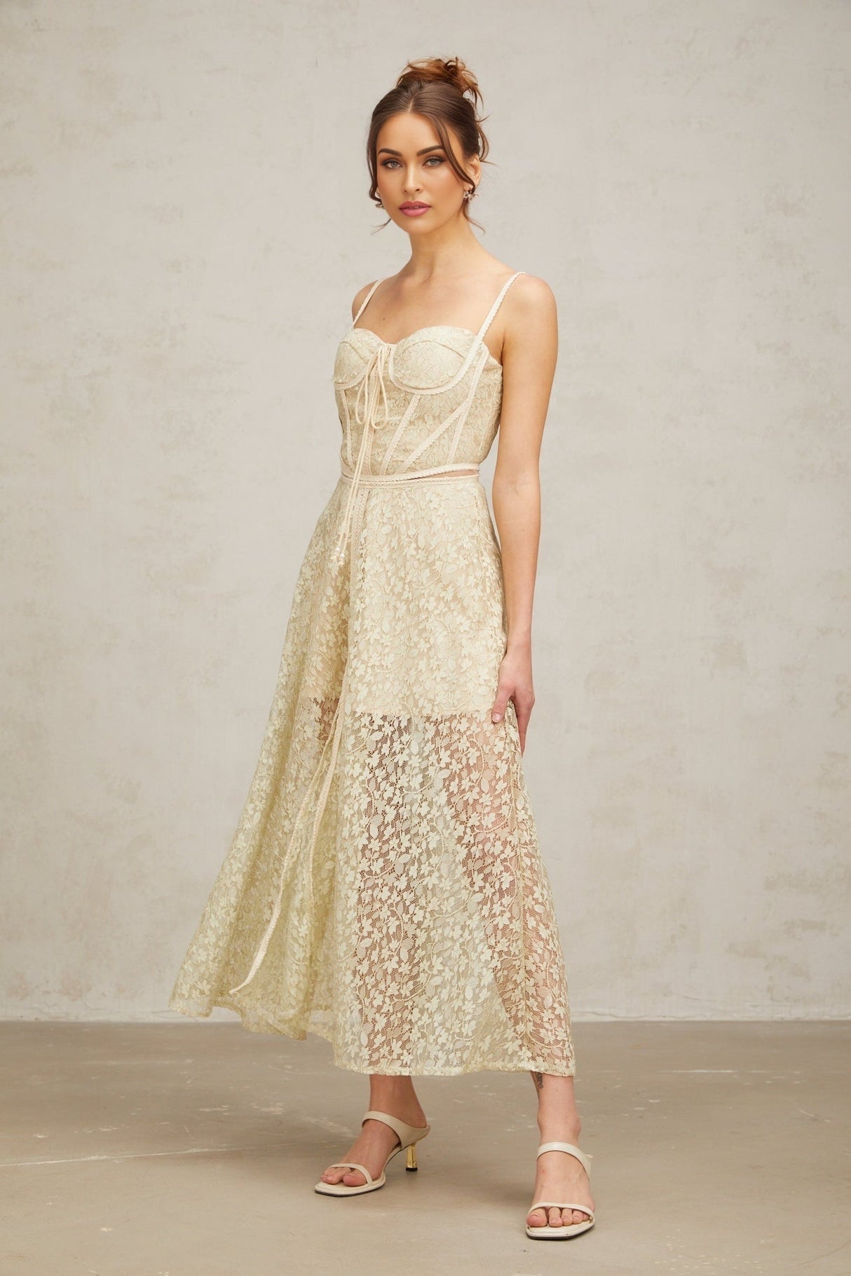 A light green midi dress with delicate floral embroidery covering the fabric featuring a feminine and elegant design