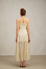 A light green midi dress with floral embroidery detailing named Yasmine