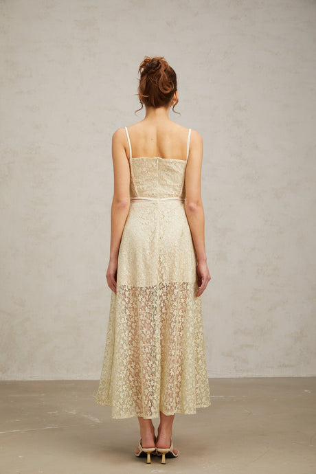 A light green midi dress with floral embroidery detailing named Yasmine