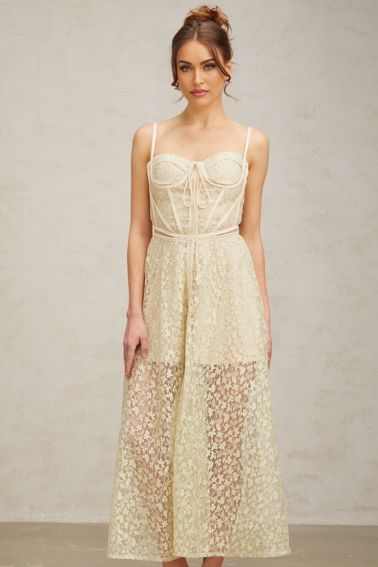 A light green midi dress with floral embroidery details featuring a feminine silhouette and delicate design