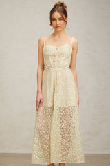 A light green midi dress with floral embroidery details featuring a feminine silhouette and delicate design
