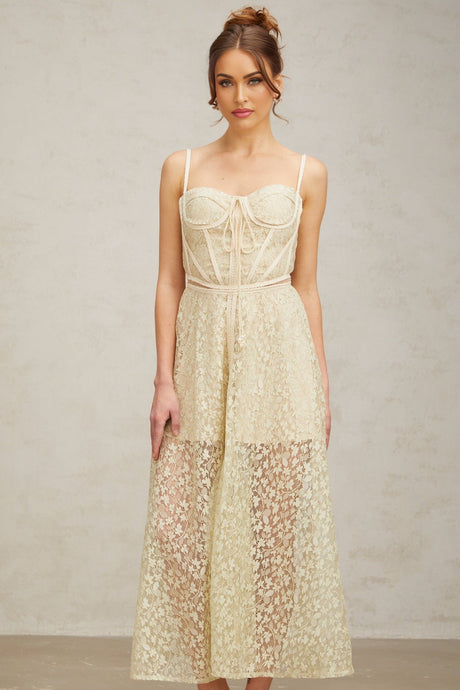 A light green midi dress with floral embroidery details featuring a feminine silhouette and delicate design