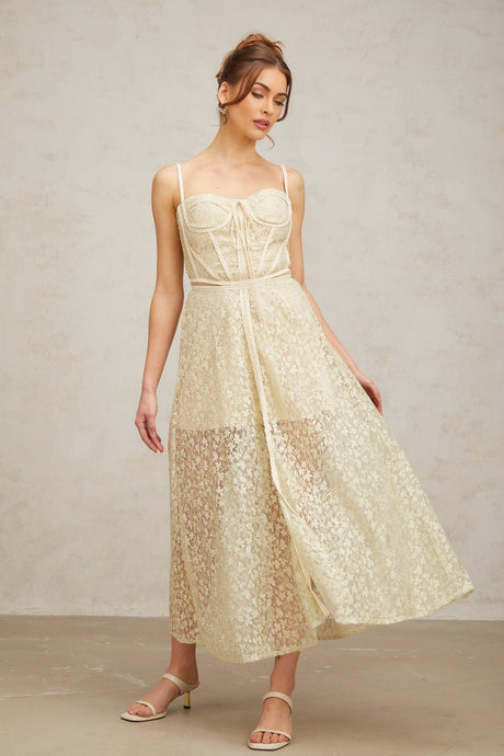 A light green midi dress with floral embroidery featuring a feminine Yasmine design