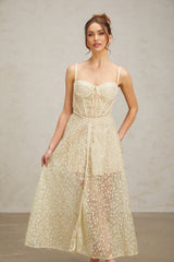 A light green midi dress with floral embroidery pattern named Yasmine